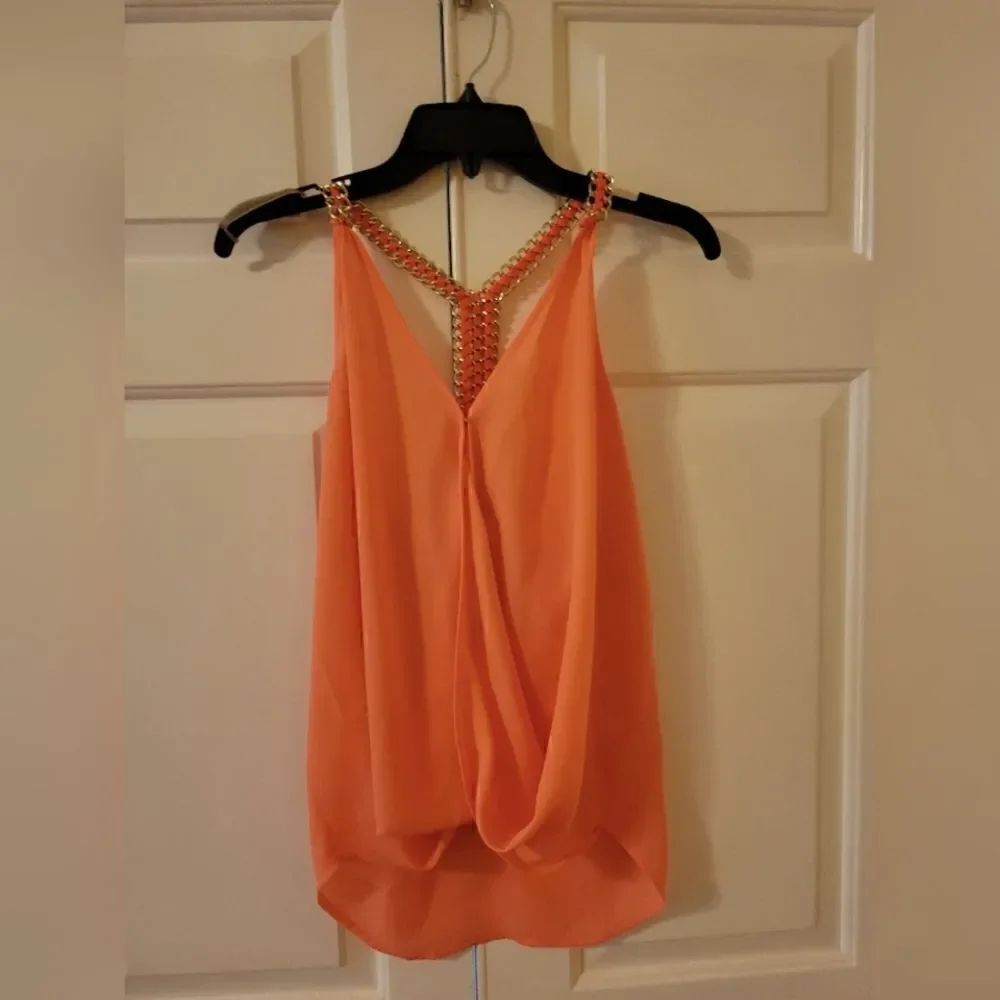 Pastel sleeveless top with gold braided strap in back